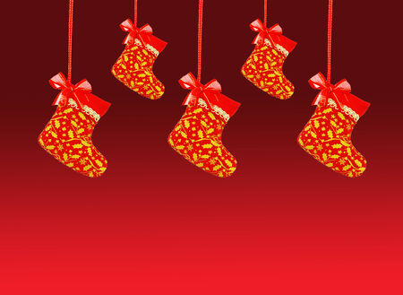 Christmas sock hanging over red background.の写真素材