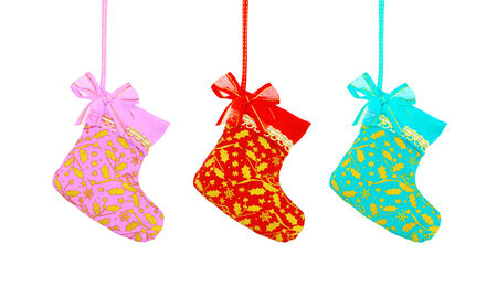 Christmas sock hanging over white background, pink red and blue colorの写真素材