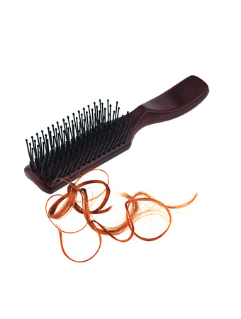 Hair loss problem with round hair brush , isolated on white background.の写真素材