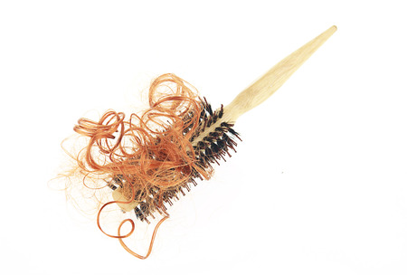 Hair loss problem with round hair brush , isolated on white background.の写真素材