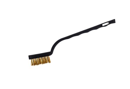 Close-up of brass brush on white background.の写真素材