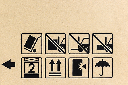 Delivery caution raised symbol on brown cardboard.の写真素材