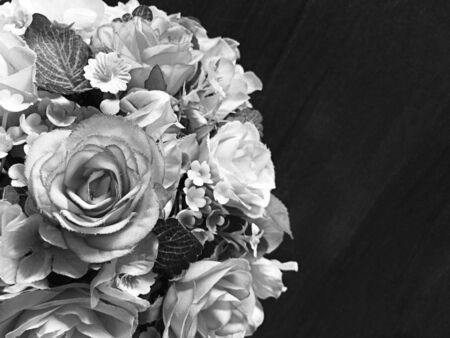 Bouquet of gray roses fake on a wooden table.の写真素材