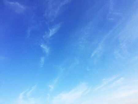 Soft white clouds against blue sky background and empty space for your design.の写真素材