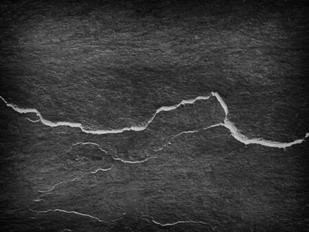 Dark gray black slate stone background or texture and empty space.の写真素材
