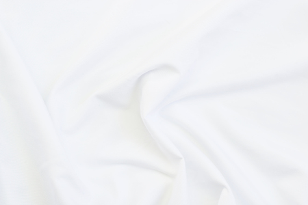 Close up of white bedding sheets and empty space.の写真素材