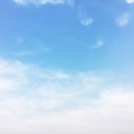 Soft white clouds against blue sky background and empty space for your design.の写真素材