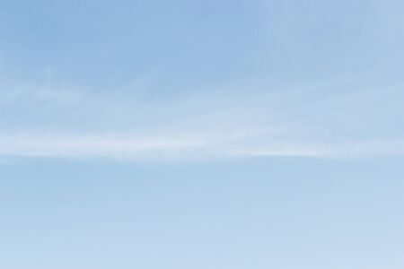 Soft white clouds against blue sky background and empty space for your design.の写真素材