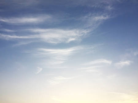 Soft white clouds against blue sky background and empty space for your design.の写真素材
