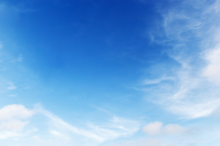 Soft white clouds against blue sky background and empty space for your design.の写真素材