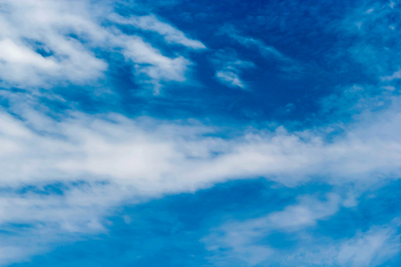 Soft white clouds against blue sky background and empty space for your design.の写真素材