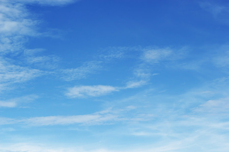Soft white clouds against blue sky background and empty space for your design.の写真素材