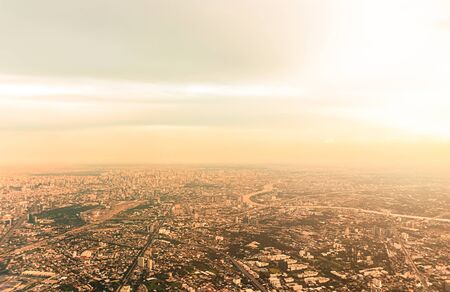 Top view Bangkok city in Thailand, at twilight time. Take a picture on airplane. Warm vintage stye color.の写真素材