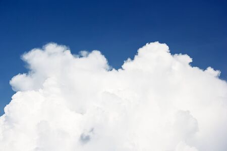 Soft white clouds against blue sky background and empty space for your design.の写真素材