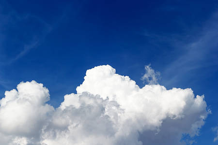 Soft white clouds against blue sky background and empty space for your design.の写真素材