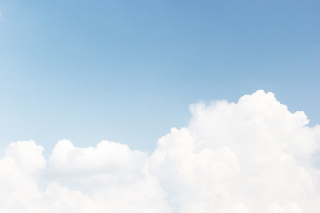 Soft white clouds against blue sky background and empty space for your design.の写真素材