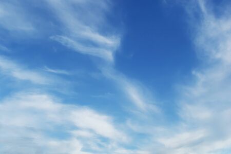 Soft white clouds against blue sky background and empty space for your design.の写真素材
