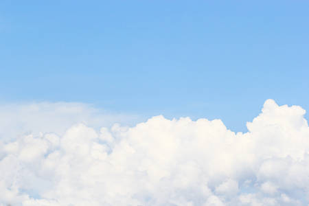 Soft white clouds against blue sky background and empty space for your design.の写真素材