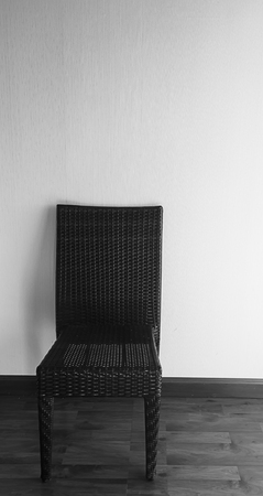 Black chair on gray floor and white wallの写真素材