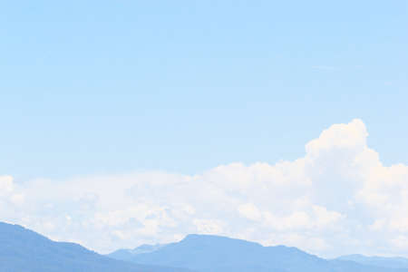 Soft white clouds against blue sky background and empty space for your designの写真素材
