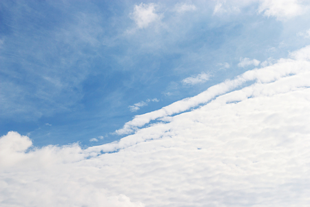 Soft white clouds against blue sky background and empty space for your design.の写真素材