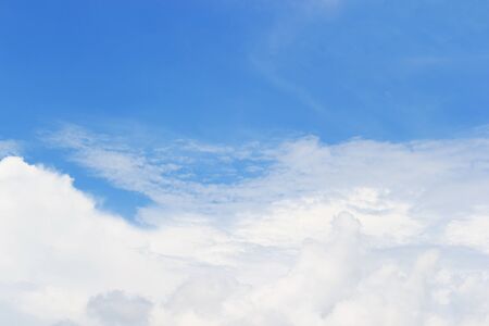 Soft white clouds against blue sky background and empty space for your design.の写真素材