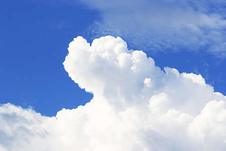 Soft white clouds against blue sky background and empty space for your design.の写真素材