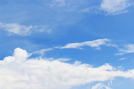 Soft white clouds against blue sky background and empty space for your design, beautiful of nature.の写真素材