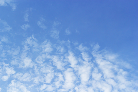 Fluffy clouds on blue sky background and empty space at center, beautiful of nature.の写真素材