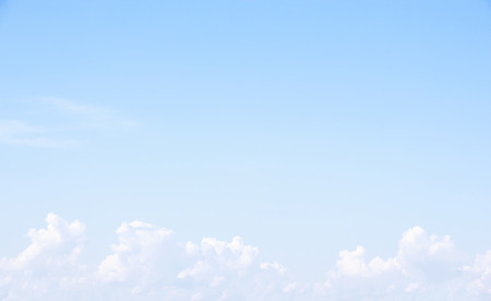 Soft white clouds against blue sky background and empty space for your design.の写真素材
