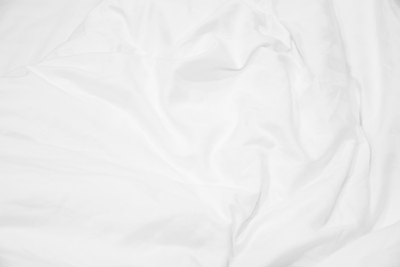 Close up of white bedding sheets and empty space.の写真素材