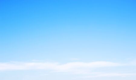 Blue sky background and white clouds soft focus, and copy-space.の写真素材