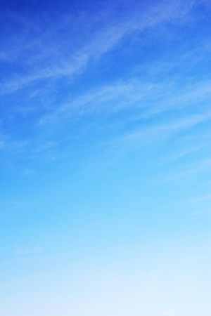 Blue sky background and white clouds soft focus, and copy space.の写真素材