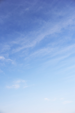 Blue sky background and white clouds soft focus, and copy space.の写真素材