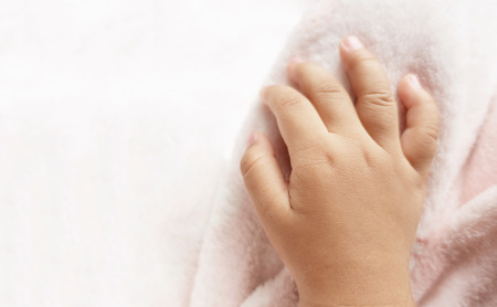 Baby hand stick catch the blanket.の写真素材