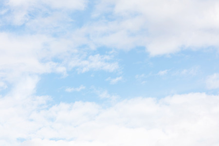 Blue sky background and white clouds soft focus, and copy space.の写真素材