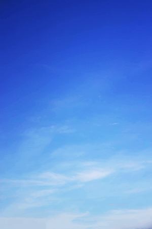 Blue sky background and white clouds soft focus, and copy space.の写真素材