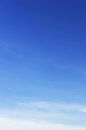 Blue sky background and white clouds soft focus, and copy space.の写真素材