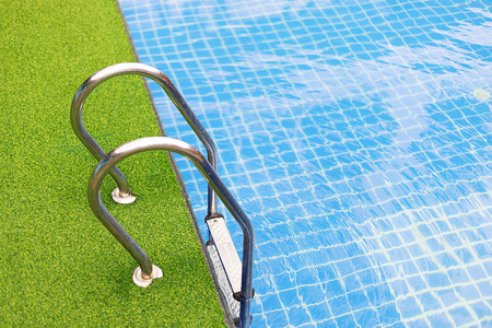 Green grass and swimming pool background and space for your design.の写真素材