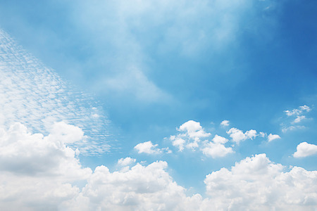 Blue sky background and white clouds soft focus, and copy space.の写真素材