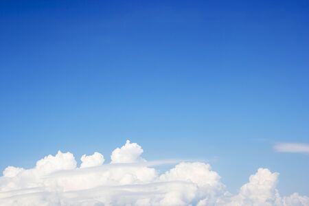 Blue sky background and white clouds soft focus, and copy space.