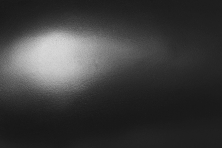 Dark gray abstract background or texture and gradients shadow with single point light.の写真素材