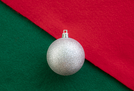 Christmas silver ball on the red and green fabricの写真素材