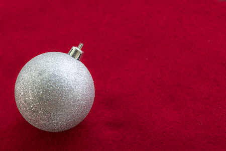 Christmas silver ball on the red fabricの写真素材