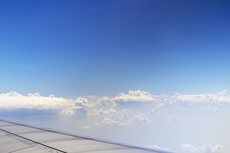 Blue sky and wing of airplaneの写真素材
