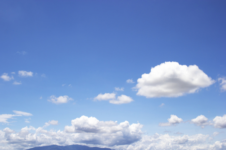 Blue sky background and white clouds soft focus, and mountain.の写真素材