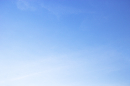 Fluffy blue sky background and white clouds soft focus, and copy space.の写真素材