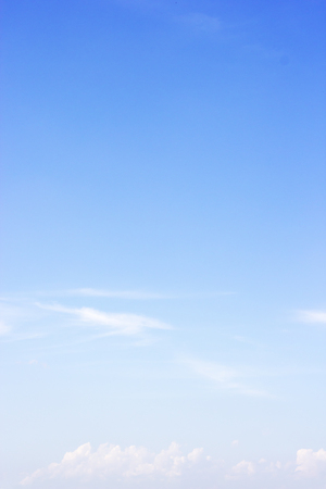 Fluffy blue sky background and white clouds soft focus, and copy space.の写真素材