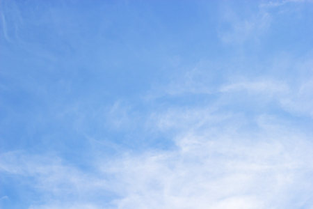 Fluffy blue sky background and white clouds soft focus, and copy space.の写真素材