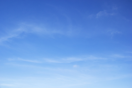 Fluffy blue sky background and white clouds soft focus, and copy space.の写真素材